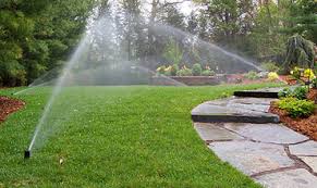 Sprinklers watering green residential lawn