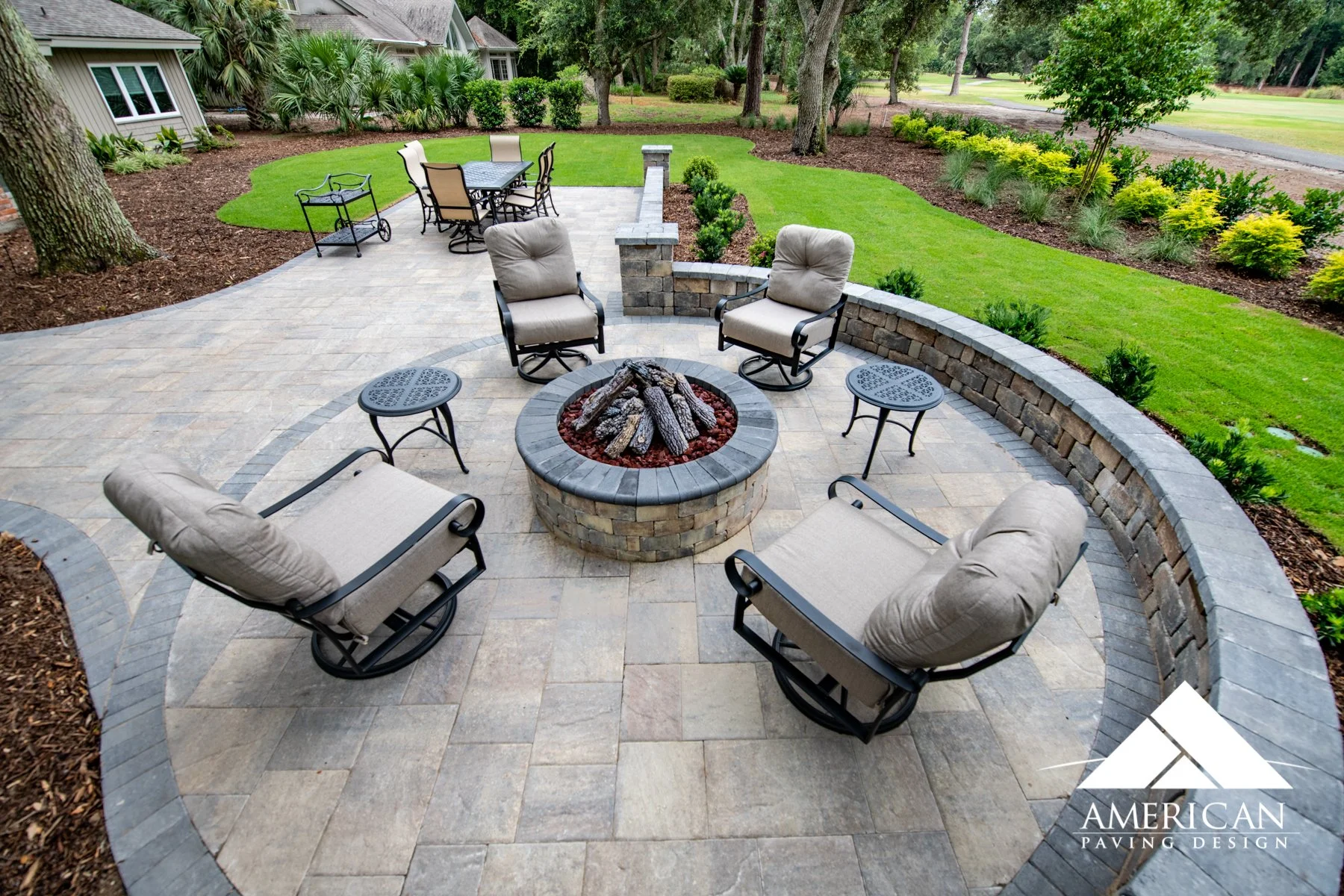 Luxury outdoor patio and fire pit with surrounding landscape